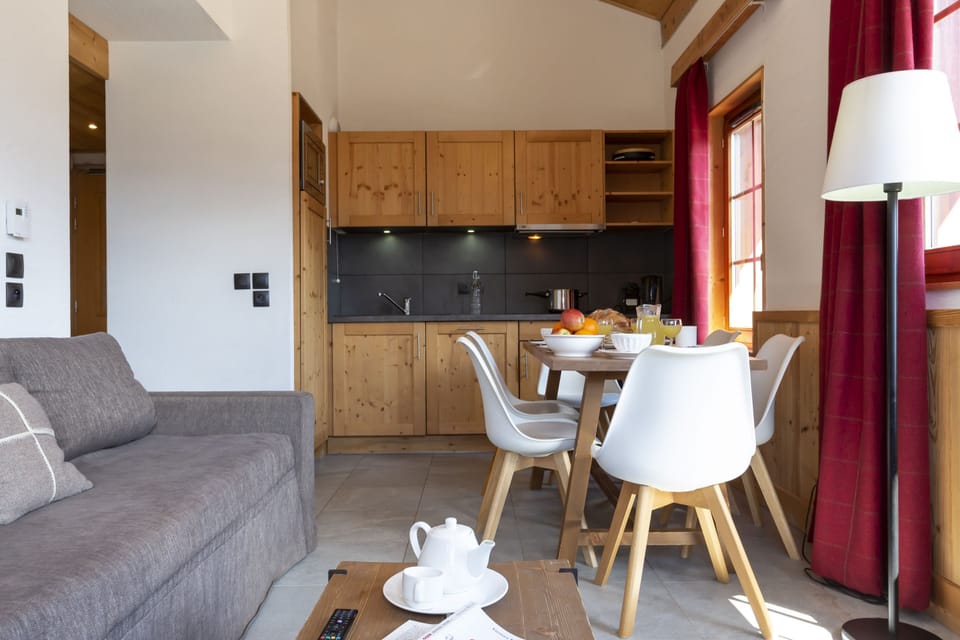 The kitchen's clean layout keeps everything within reach — from the capsule coffee maker to the dishwasher.