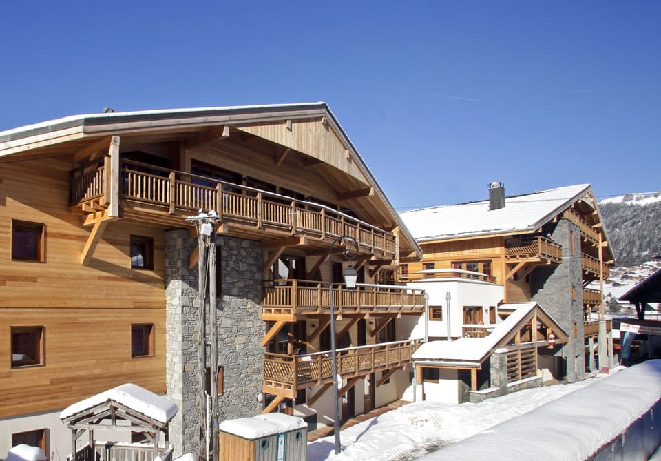 Built in traditional Savoyard stone and timber, the residence blends into Châtel village while keeping the slopes just steps away.