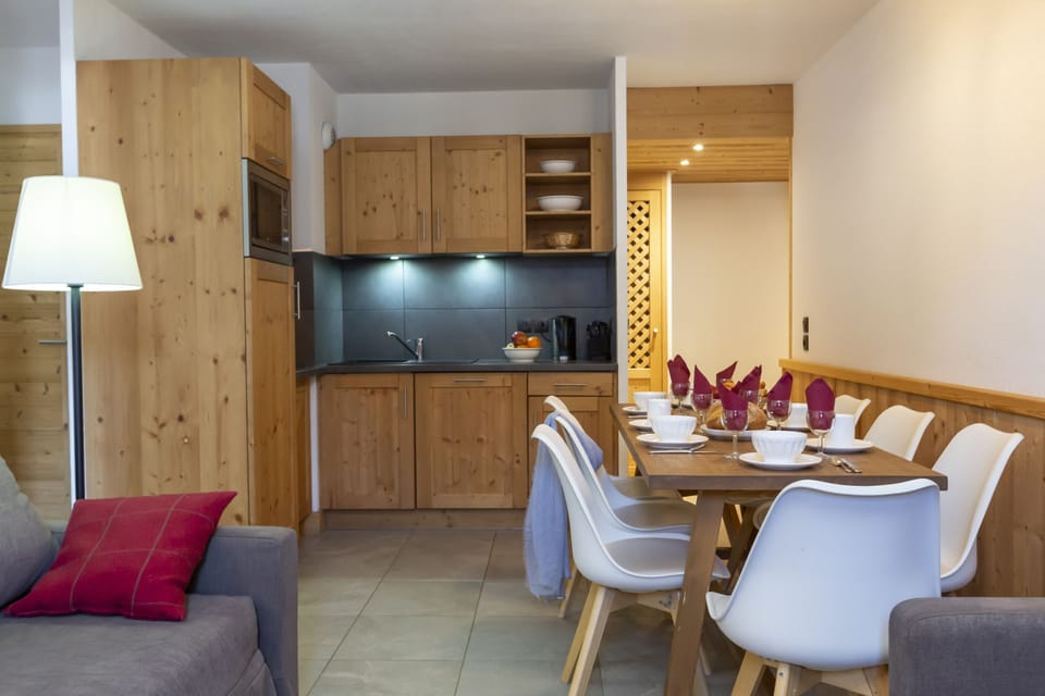 The kitchen and dining area from another angle, showing how naturally the space flows for group meals and morning coffee.