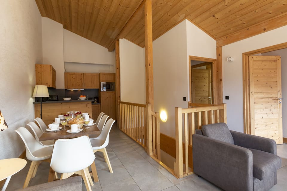 The kitchen and dining area flow together in an open layout, with the staircase to the upper level just beyond.