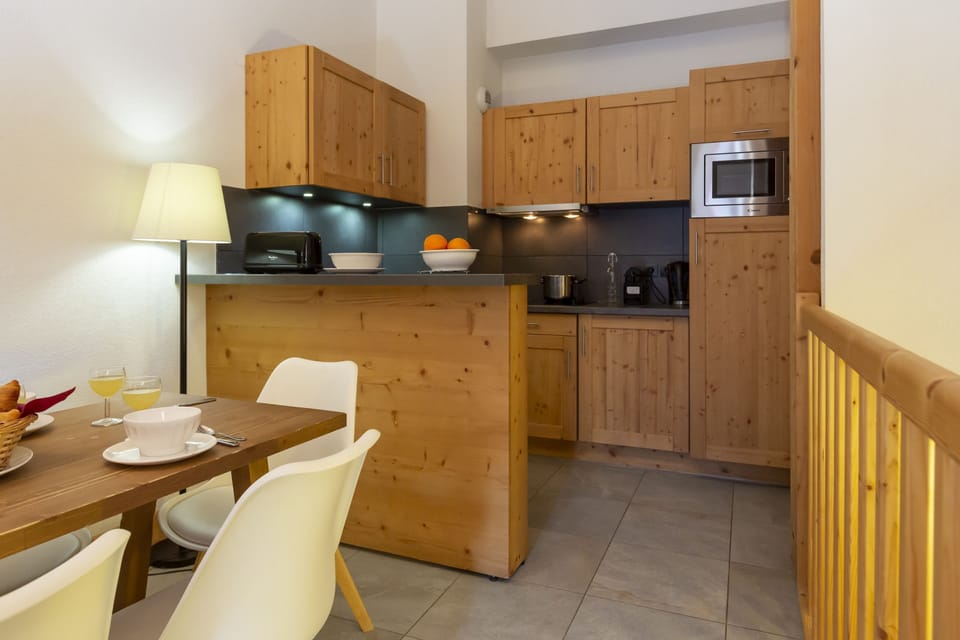 A closer look at the kitchenette — the capsule coffee maker and well-stocked countertops ready for a full ski week.