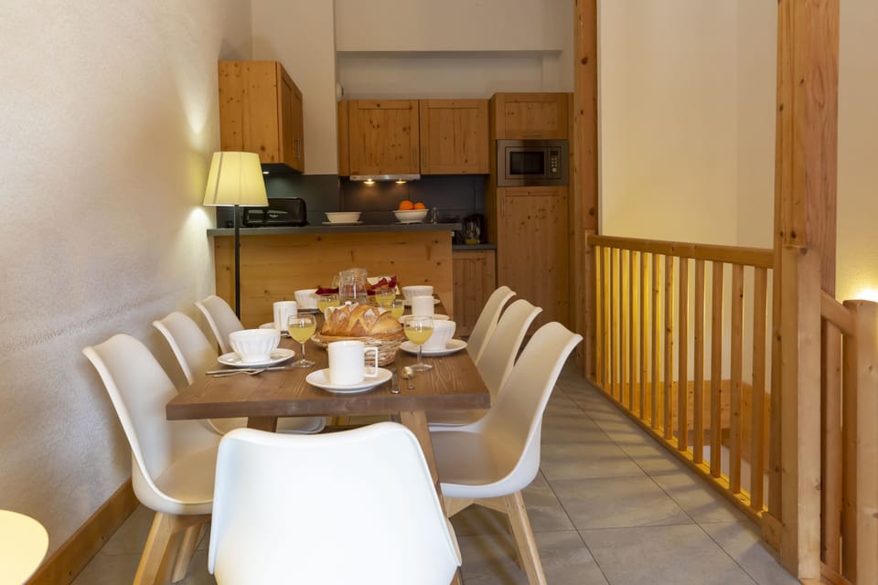 The dining area from another angle — the open-plan layout and warm wood tones make the 63 m² feel generous and connected.