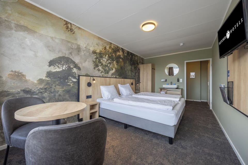 Unwind in a spacious room with cozy seating and mural.