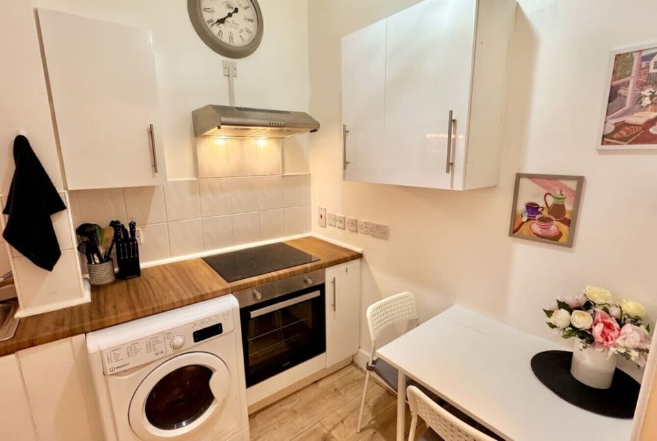 Bright kitchen with oven, hob and a cosy nook for morning coffee.