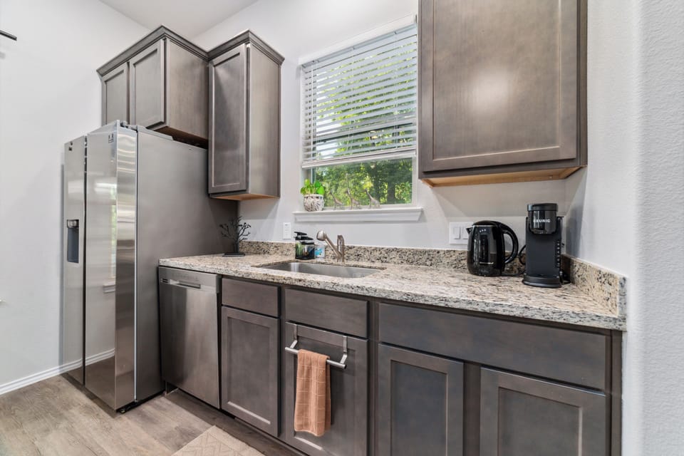 Bright modern kitchen with granite counters and stainless appliances
