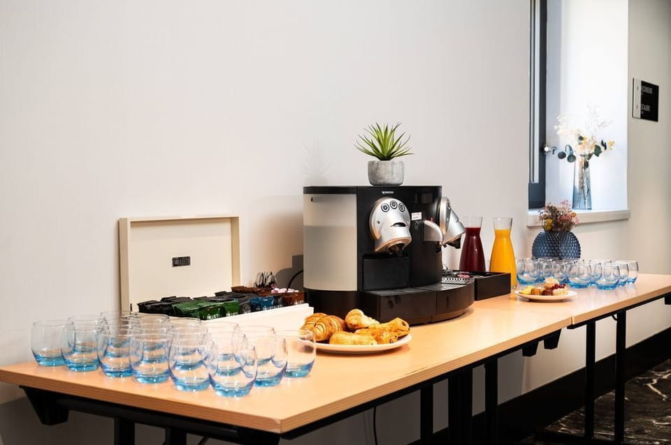 Coffee and pastries at the hotel's breakfast station — breakfast is included in your stay.