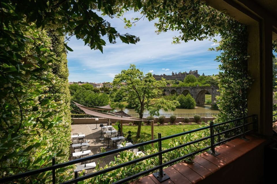 Views of the Aude River and the Cité Médiévale framed by the hotel's ivy-covered walls — steps from your room.