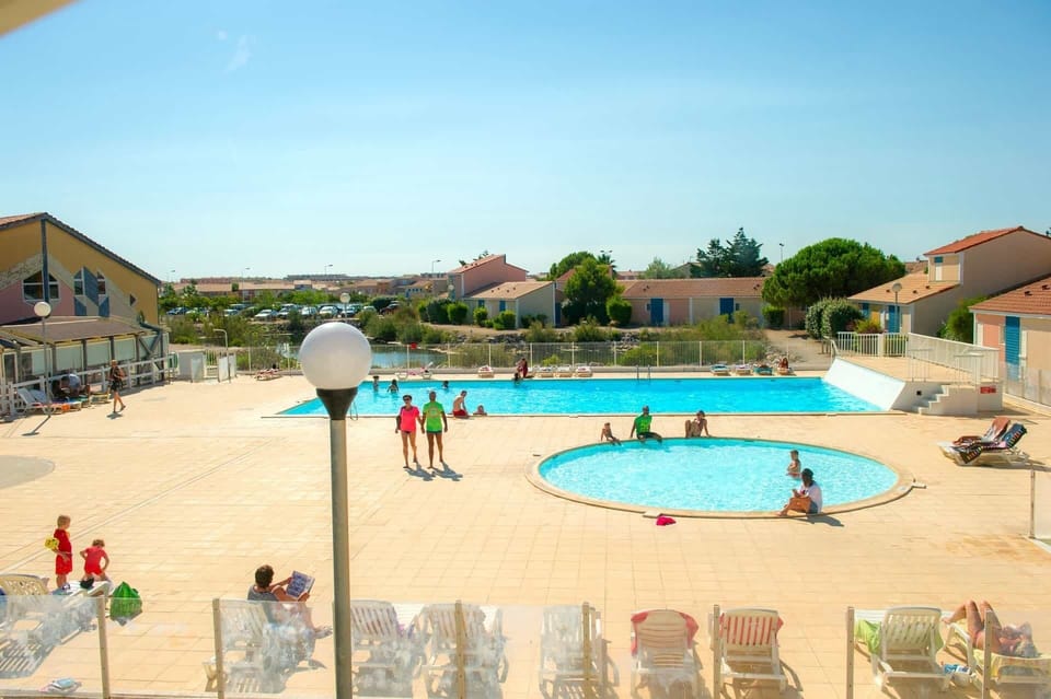 The resort's main outdoor pool, one of two swimming areas on-site, perfect for long sunny afternoons on the Occitanie coast.