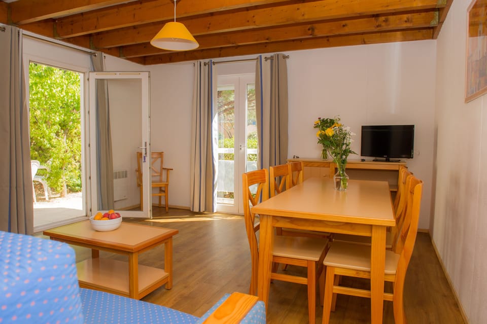 Light floods the living space through terrace doors, creating an airy feel for up to six guests.