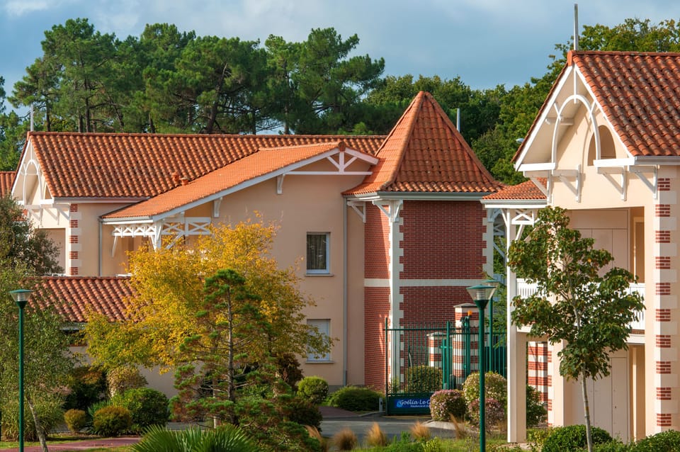 Traditional Soulac-style architecture with white stone, brick, and exposed timber beams.