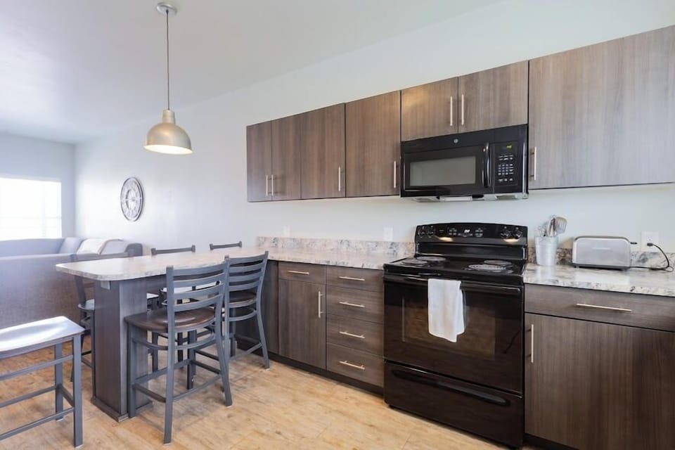 Full kitchen featuring all essential appliances, cookware, utensils, dishes, and cutlery.