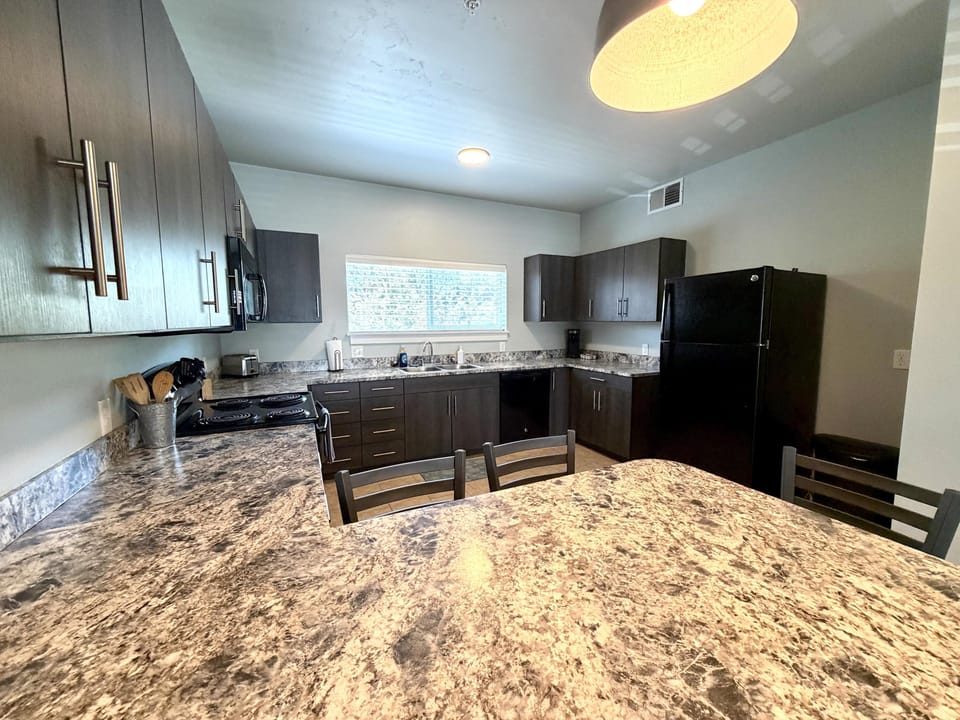 Full kitchen featuring all essential appliances, cookware, utensils, dishes, and cutlery.