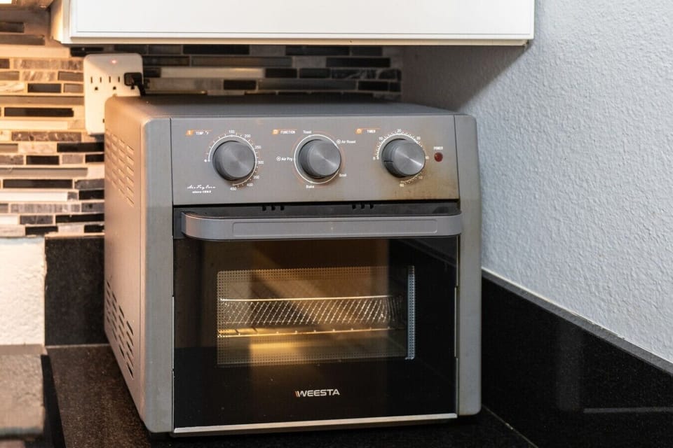 Modern air fryer toaster oven for quick and easy meals during your stay.