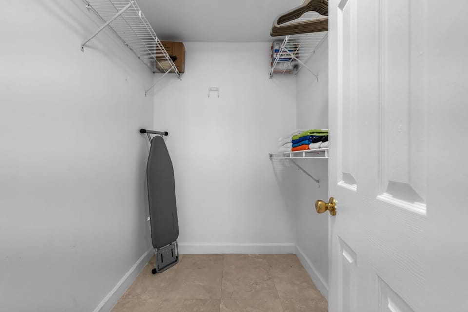 Generous walk-in closet with plenty of shelving and hanging space. Room for everything from wardrobe to extras, with an ironing station ready to go. Smart storage that keeps your essentials organized and out of sight.
