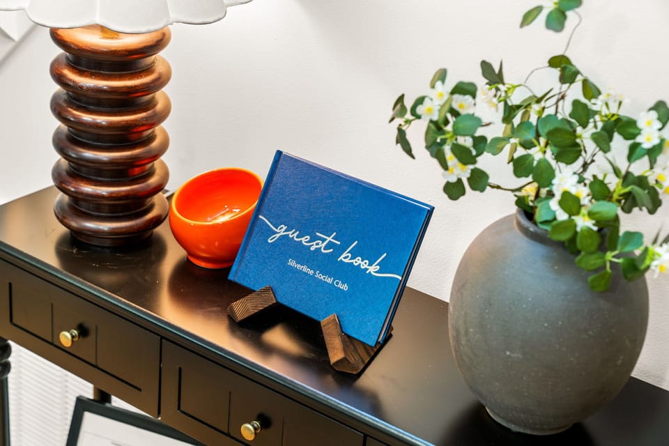 Stylish welcome vignette with guest book and elegant decor accents