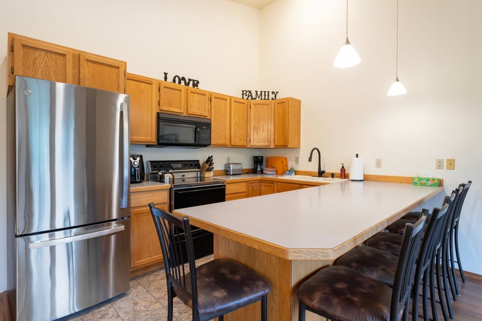 A full kitchen and bar seating | Interior