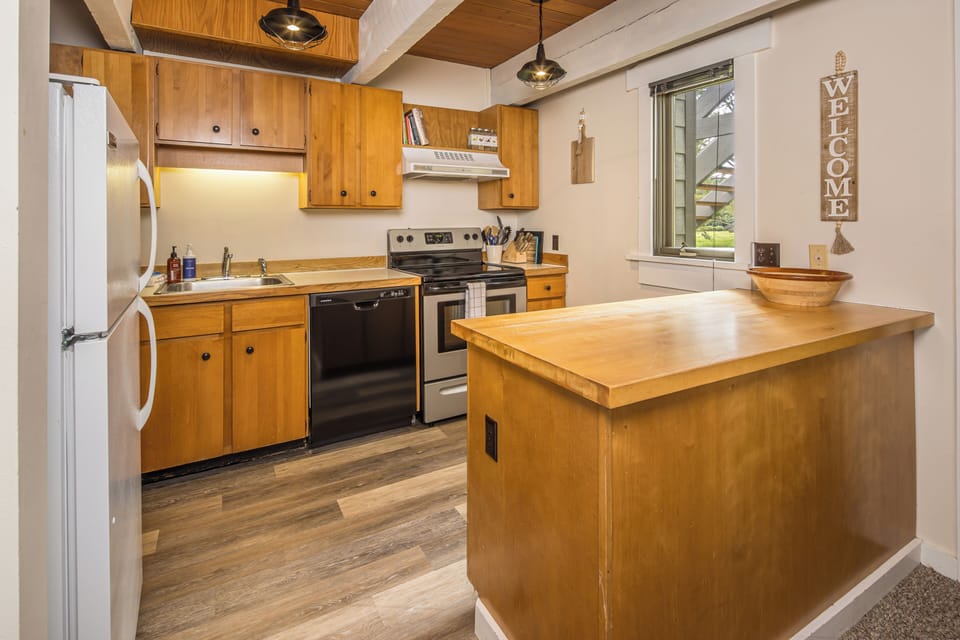 Kitchen with warm wood finishes | Main Level