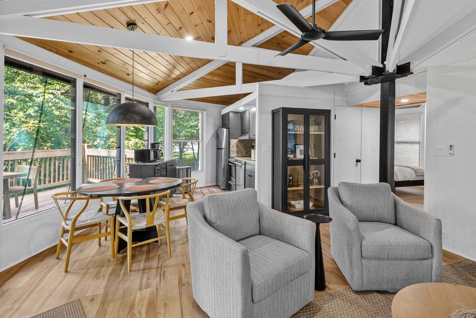 Vaulted wood ceilings and walls of windows make every meal feel like a treehouse experience at Birdie Bungalow.