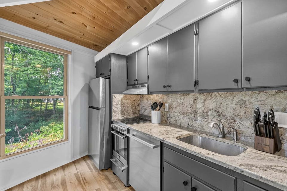 Granite counters, stainless appliances, and a wood-planked ceiling make cooking at Birdie Bungalow a pleasure.