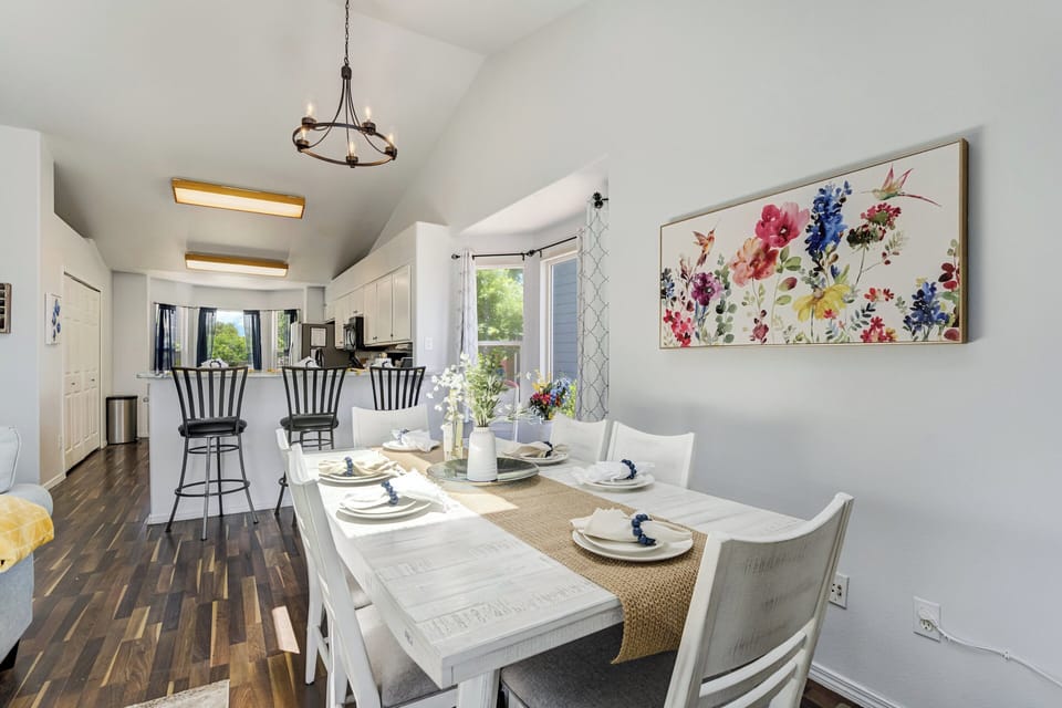 The dining area seats six, with three additional seats at the kitchen bar and a cozy breakfast table for three beside the bay window, giving everyone plenty of room to gather for meals.