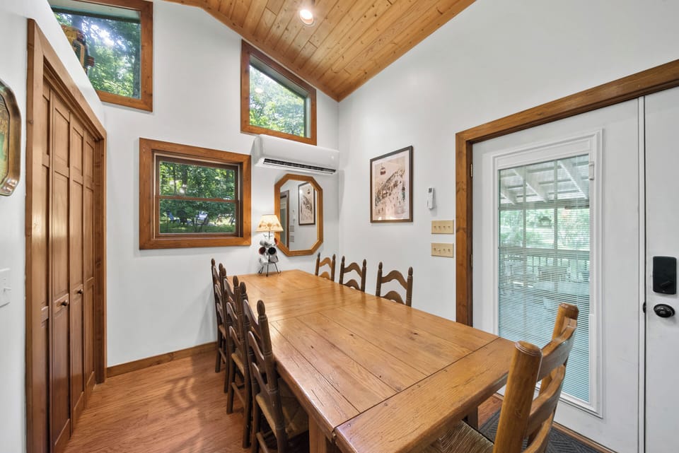 Welcoming dining area with seating for shared meals and views of the surrounding trees