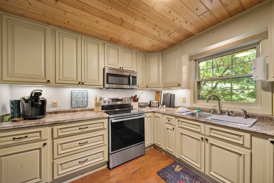 Fully equipped kitchen with generous counter space and peaceful wooded views