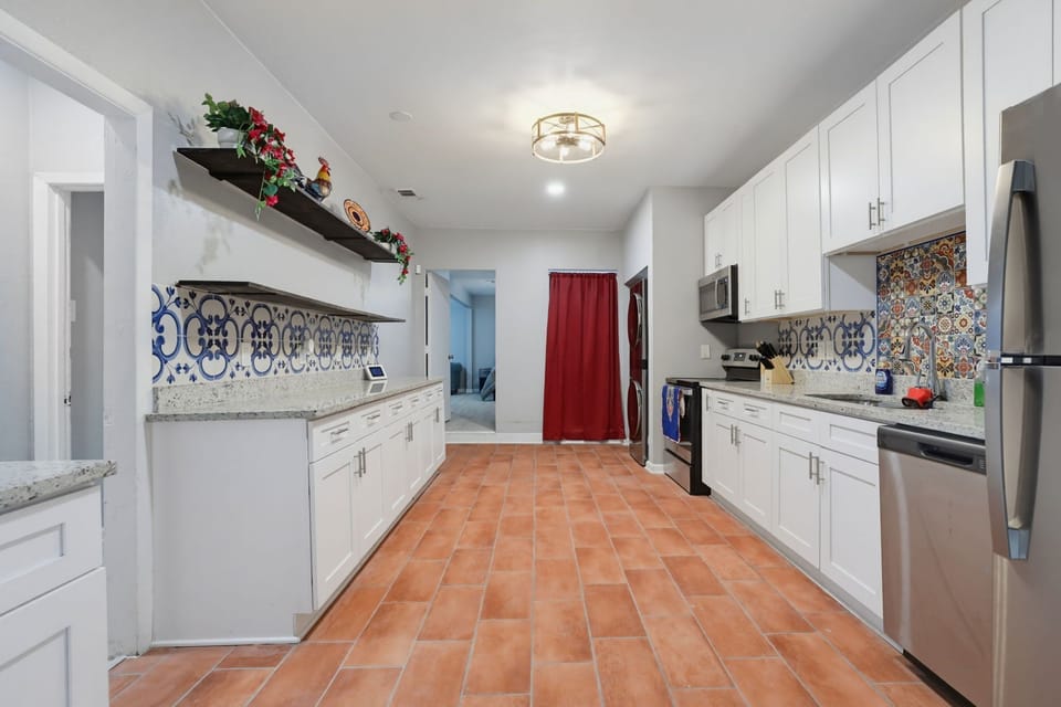 Spacious chef-friendly kitchen with custom tile and stainless appliances