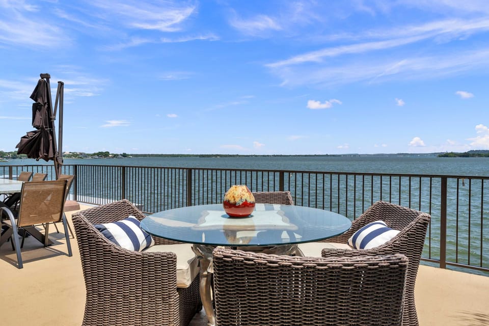 Upper level patio w/ outdoor seating, BBQ grill, & panoramic lake views
