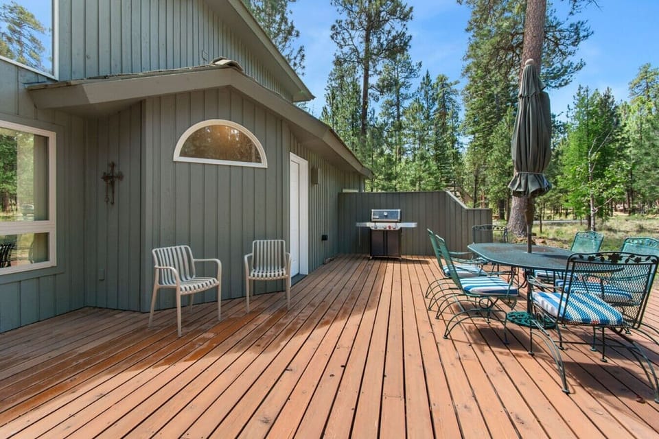 Relax on the spacious back deck surrounded by towering pines.