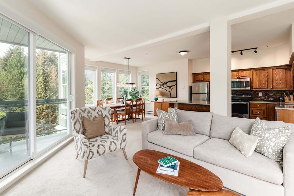 Living Room - Queen sofa bed, open-concept flow to kitchen and dining — bright, airy, room to spread out