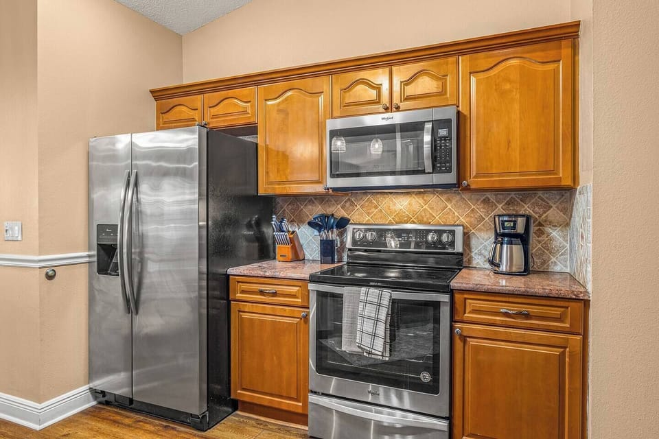 Full kitchen with stainless appliances and generous counter space.