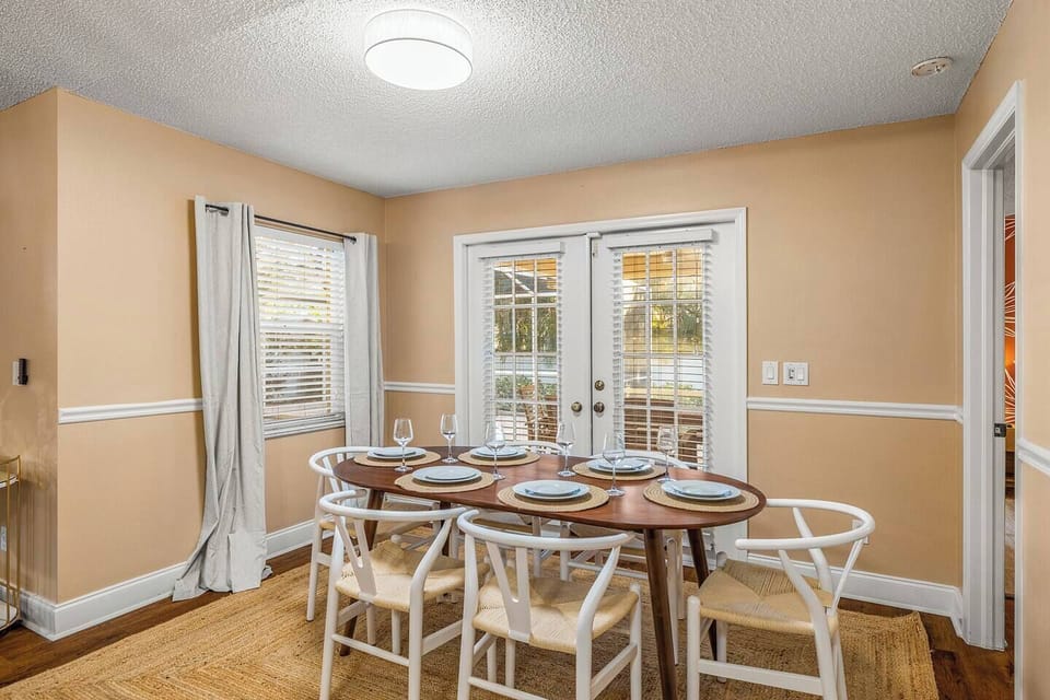 Dining area with French doors opening to the screened lanai.