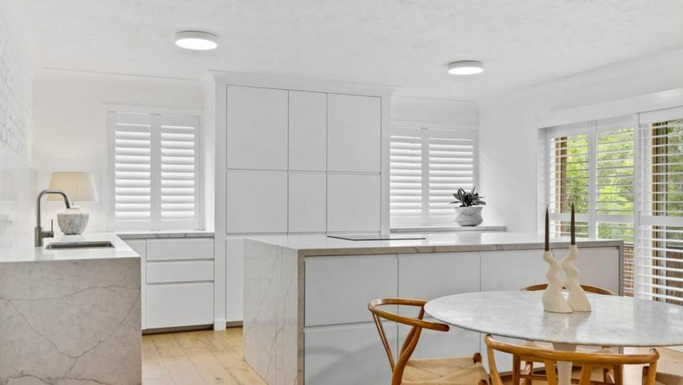 The stylish kitchen is fully equipped with quality appliances, ample storage, and generous bench space.