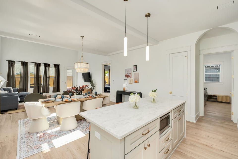 Bright open-concept kitchen, dining & living area with elegant island