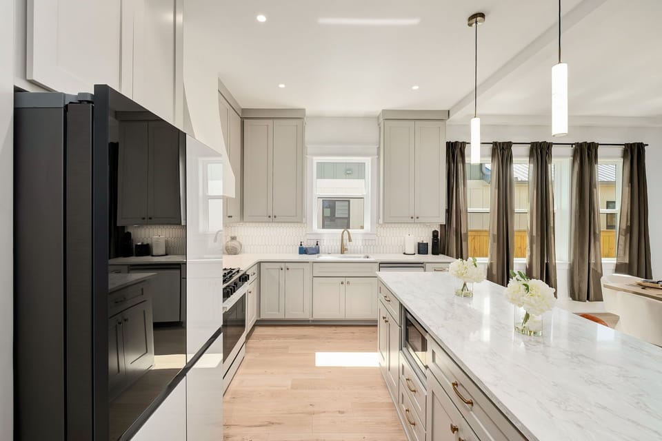 Bright designer kitchen with oversized island and elegant modern finishes