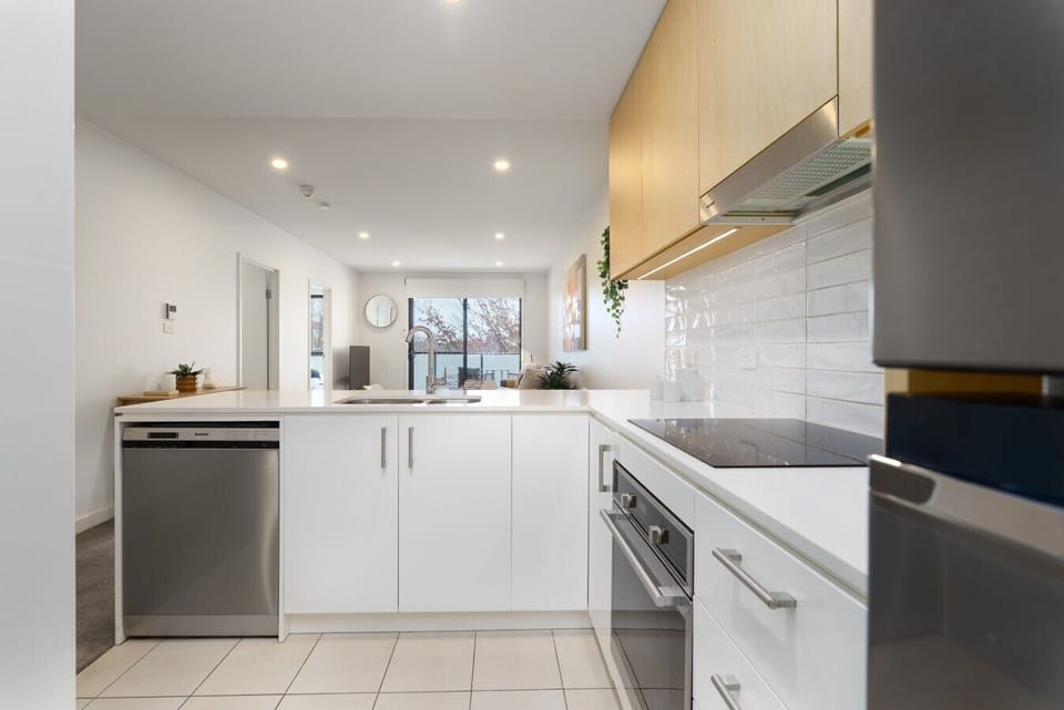 The bright and modern kitchen offers quality appliances, ample bench space and all the essentials for home-style cooking.