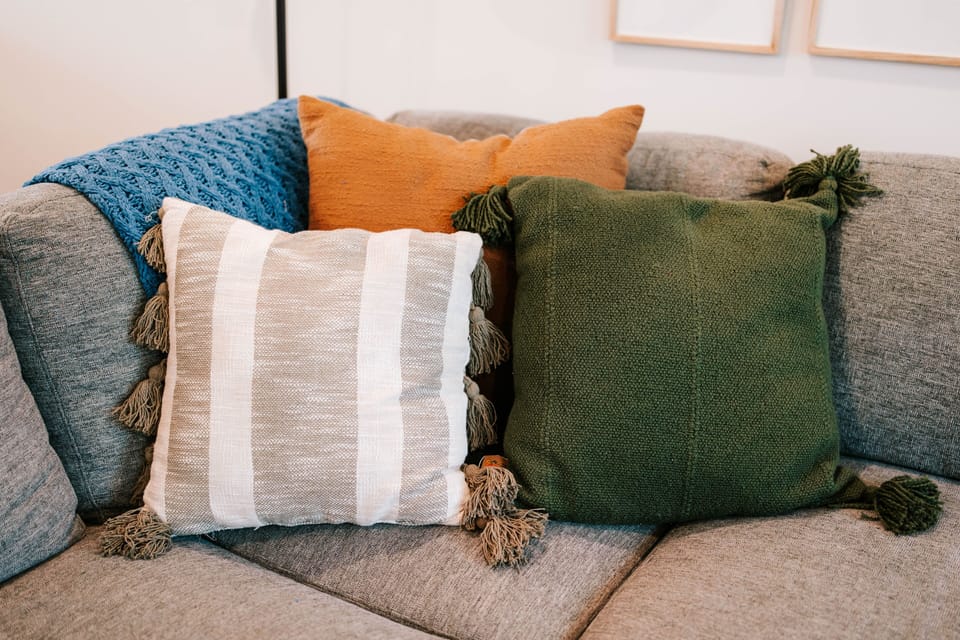 Soft pillows and rich textures make the sofa easy to sink into.