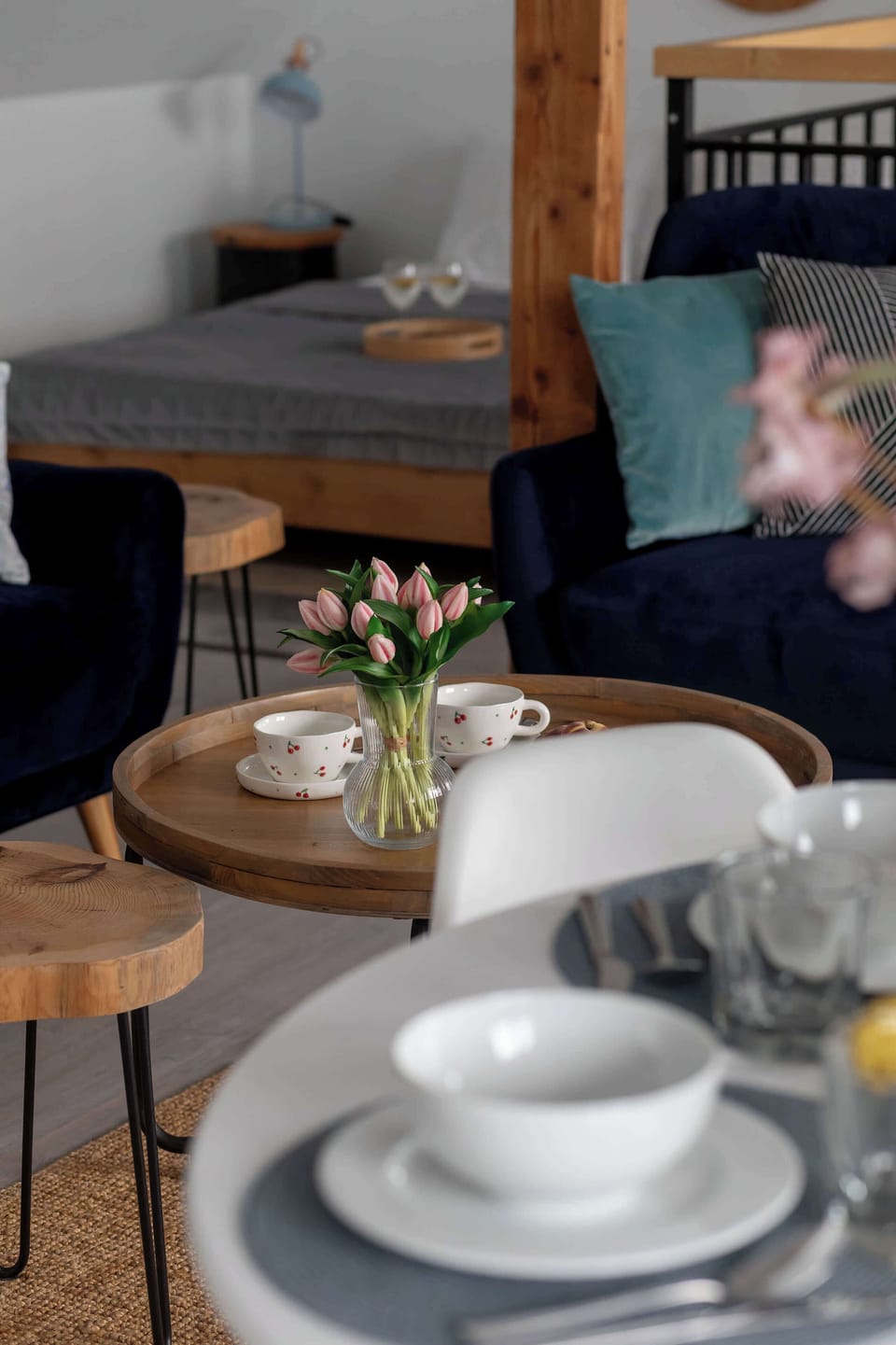 Dining table set for guests with a view towards the comfortable living room.