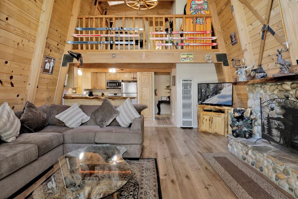 Relax by the stone fireplace. Classic Big Bear cabin warmth with room for the whole group to kick back and unwind.