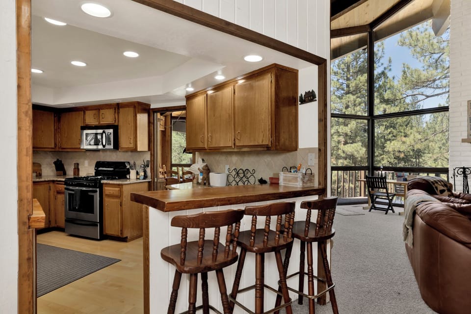 Fully equipped cabin kitchen with ample cabinetry, stove, fridge, and coffee maker—perfect for cooking meals, morning coffee, and feeling right at home on your stay.