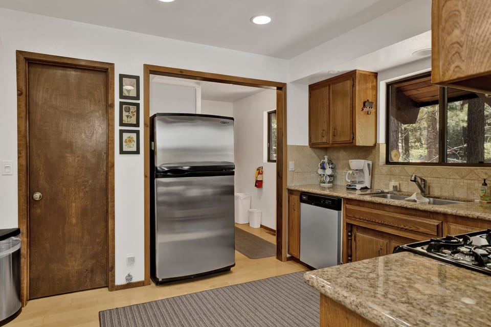 Fully equipped cabin kitchen with ample cabinetry, stove, fridge, and coffee maker—perfect for cooking meals, morning coffee, and feeling right at home on your stay.