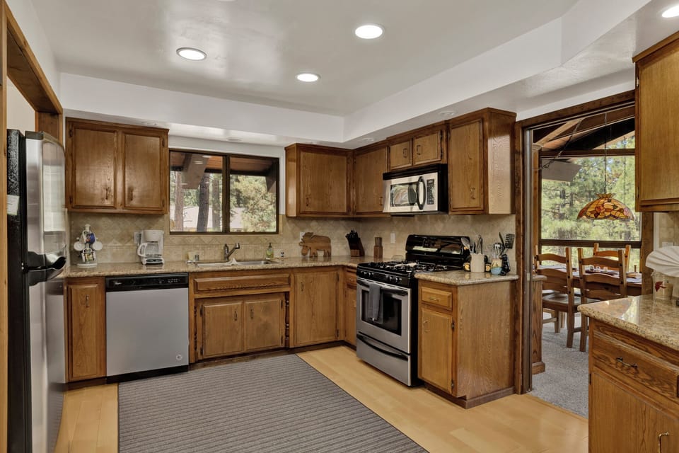 Fully equipped cabin kitchen with ample cabinetry, stove, fridge, and coffee maker—perfect for cooking meals, morning coffee, and feeling right at home on your stay.