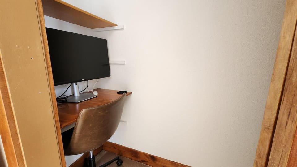 Step into your private workspace—a dedicated desk, ergonomic chair, and flatscreen monitor await, giving you everything you need to stay productive during your stay.