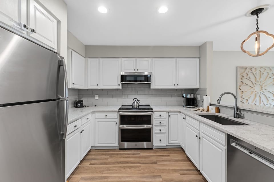 Your fully equipped kitchen makes meal prep a breeze with stainless appliances, modern countertops, and crisp white cabinetry—everything you need to cook, dine, and feel right at home.