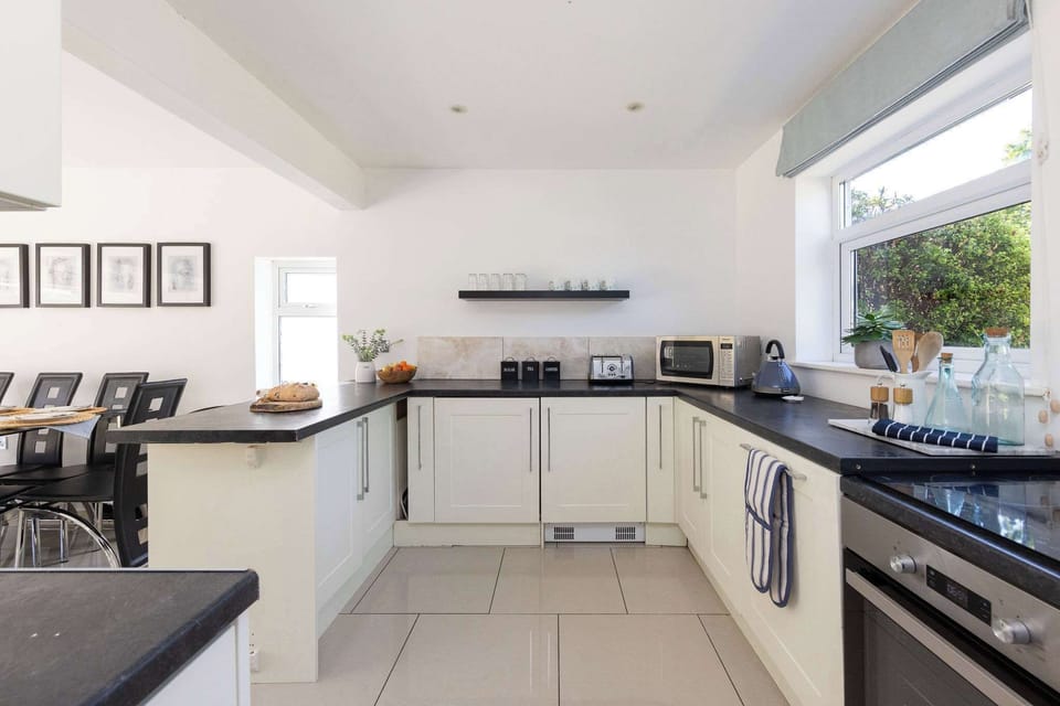 Prepare meals in the modern, fully equipped kitchen of this bright family getaway property.