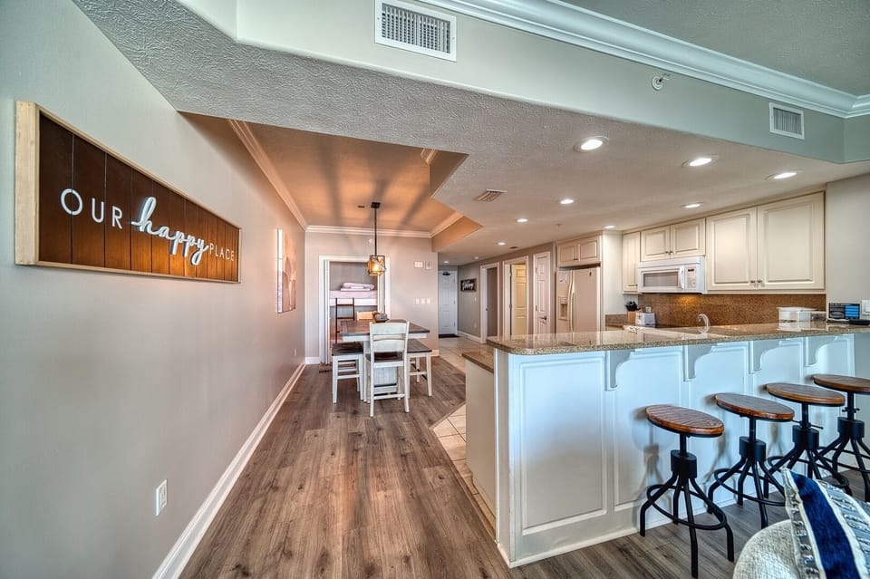Step into your happy place with this bright, open layout featuring a fully-equipped kitchen, dining nook, and cozy living spaces—your coastal retreat awaits.