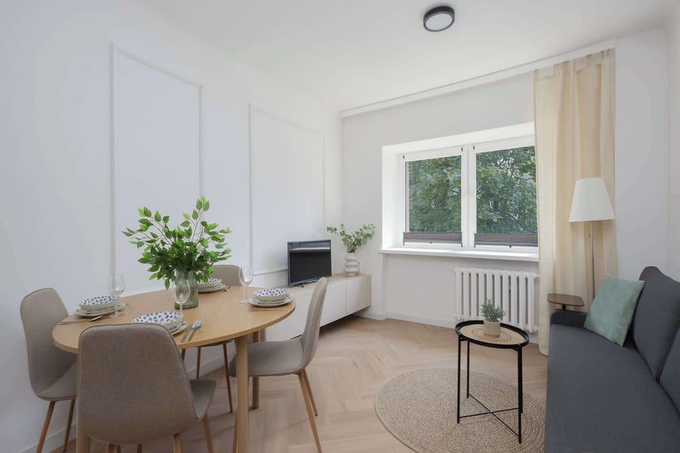 A stylish dining corner with a table by the window, perfect for enjoying breakfast or dinner. The bright interior creates a warm and inviting atmosphere.