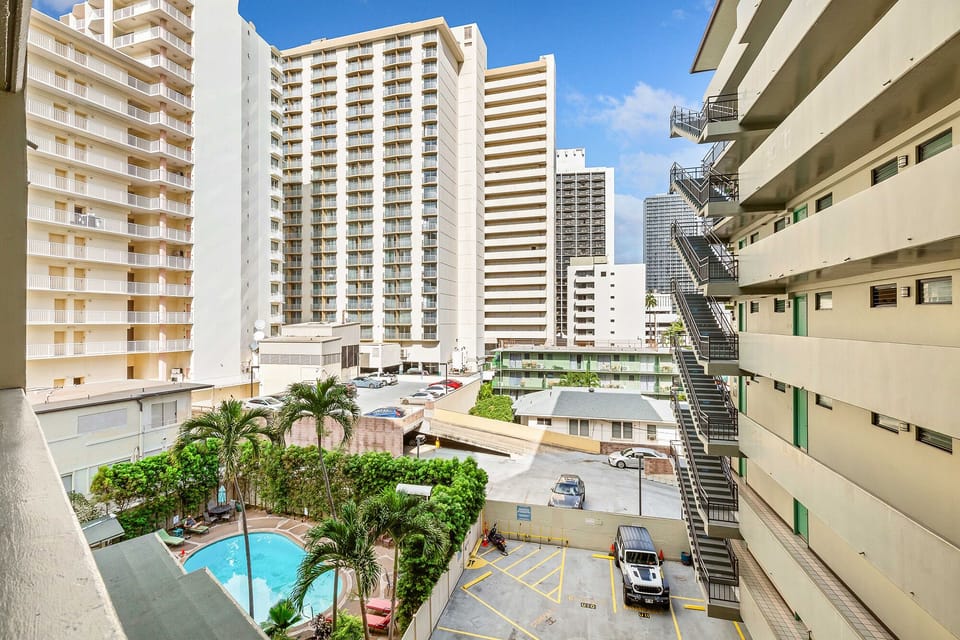 Urban high-rise property located in a lively area with nearby buildings, a community pool, and parking facilities—perfect for city explorers seeking convenience.