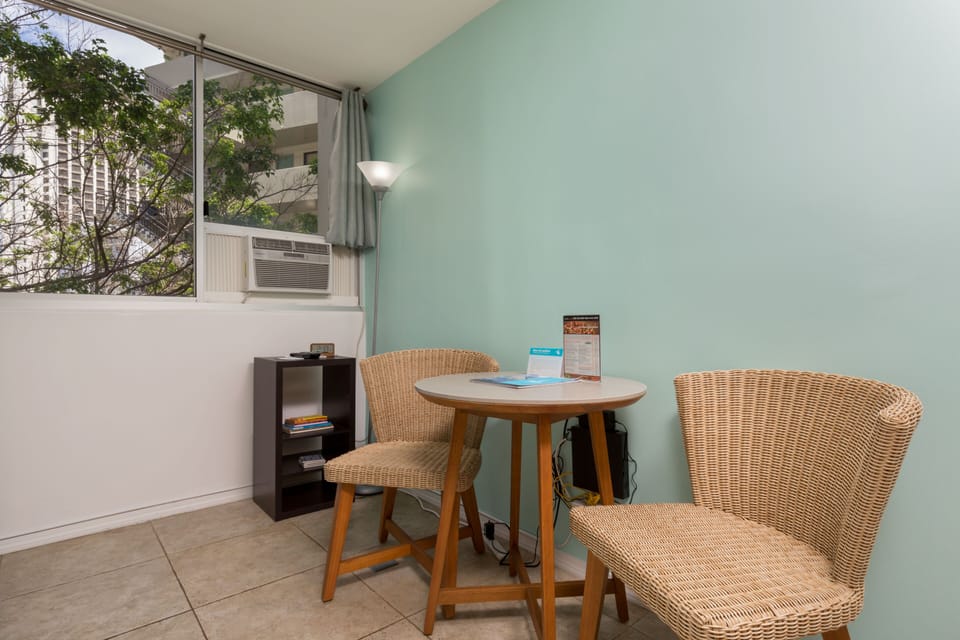 Settle into your cozy corner with wicker seating and a bright window view, perfect for morning coffee or quiet reading moments.