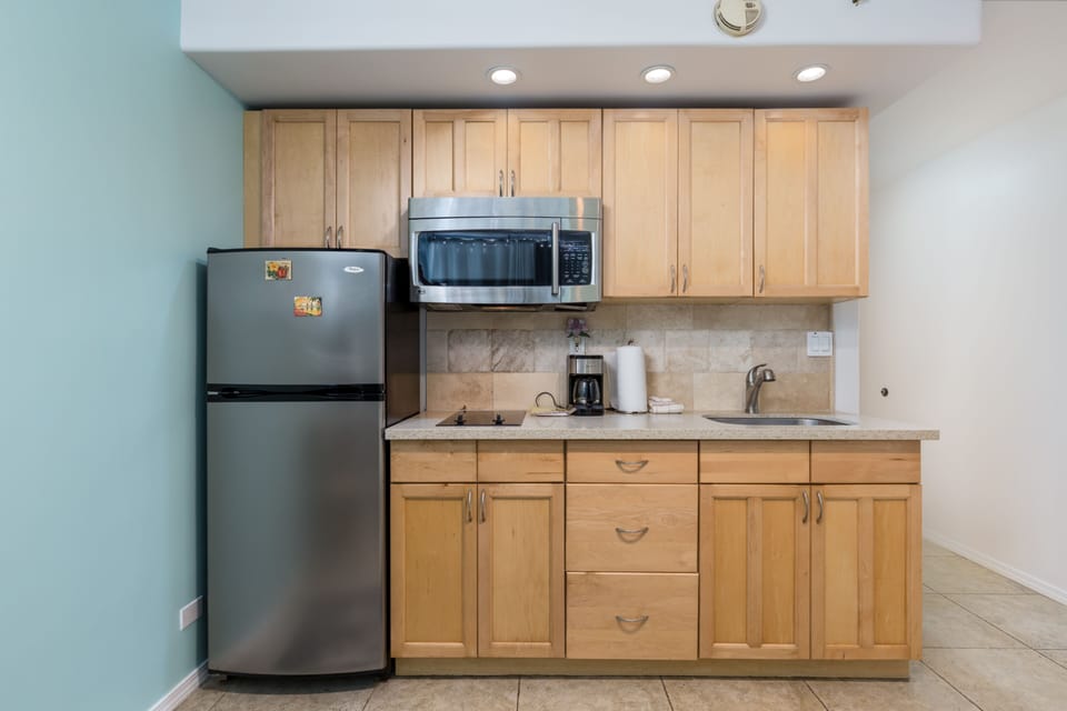 Your fully equipped kitchen features warm wood cabinetry, stainless steel appliances, and everything you need to prepare meals during your stay.
